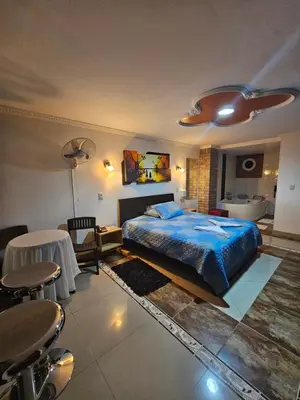 a bedroom with a bed and a table and a bathroom at HOTEL MONTERREY in Ruiosucio