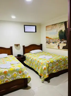 two beds sitting next to each other in a bedroom at HOTEL MONTERREY in Ruiosucio