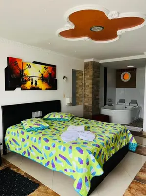 a bedroom with a bed and a bathroom with a sink at HOTEL MONTERREY in Ruiosucio