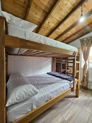 two bunk beds in a room with wooden ceilings at Cabaña Los Colibríes in San Rafael