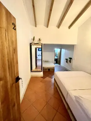 a bedroom with a bed and a mirror in a room at Finca Hotel el Valhalla in Doradal