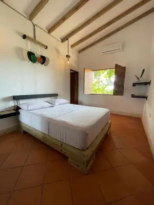 a bedroom with a large bed in a room at Finca Hotel el Valhalla in Doradal