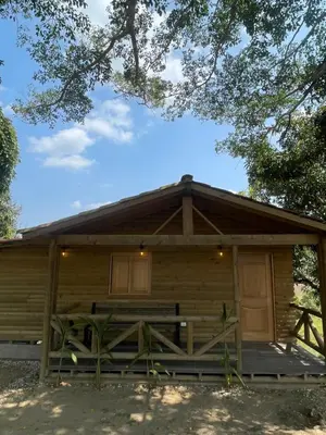 a log cabin with a porch and a door at Finca Hotel el Valhalla in Doradal