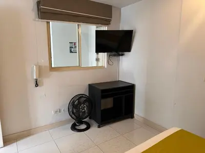 a room with a flat screen tv on a wall at Amoblados Medellin Estadio in Medellín