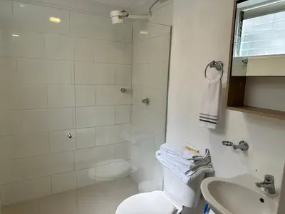 a bathroom with a shower and a toilet and a sink at Amoblados Medellin Estadio in Medellín