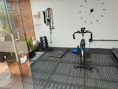 a bike in a room with a clock on the wall at Orange Suites by Vibra Bonita in Medellín