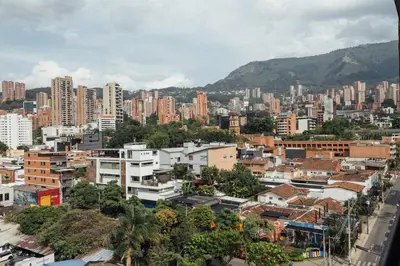 a city with tall buildings and a mountain at Orange Suites by Vibra Bonita in Medellín