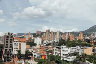 a city skyline with tall buildings and trees at Orange Suites by Vibra Bonita in Medellín