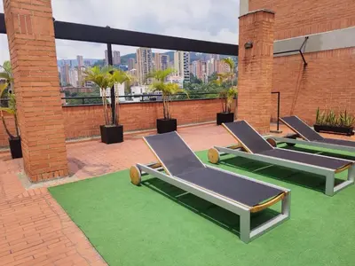 a group of lounge chairs on a roof at Orange Suites by Vibra Bonita in Medellín