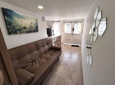 a living room with a couch and a kitchen at Apartaestudio S101 a 2 calles de Milán Urbanevo in Manizales