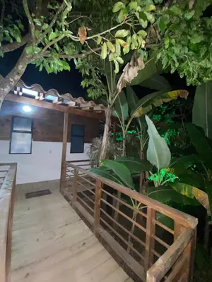 a room with a tree and a wooden deck at Eco Hotel La Italia- Hotel Venecia, Antioquia in Venecia