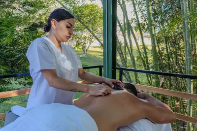 a woman is giving a man a massage at Shabbat Hotel Boutique in San Vicente
