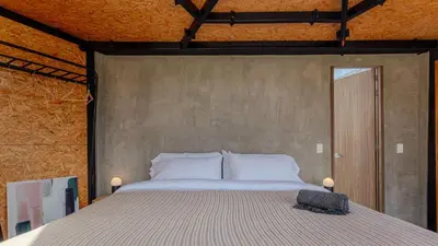 a bedroom with a large bed with white pillows at Shabbat Hotel Boutique in San Vicente