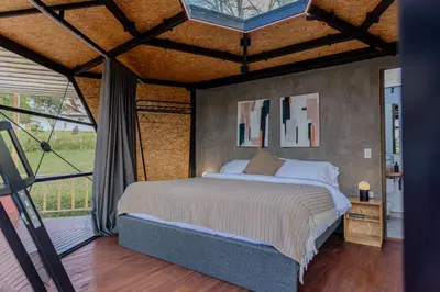 a bedroom with a bed and a large window at Shabbat Hotel Boutique in San Vicente