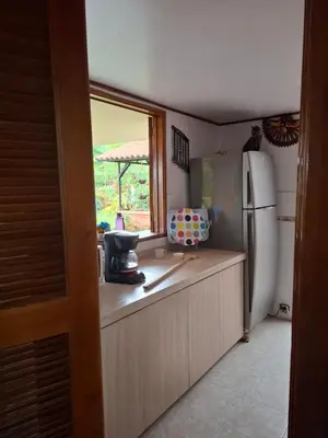 a kitchen with a refrigerator and a window at Finca villa carolina, eje cafetero in La Floresta