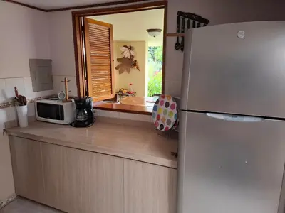a kitchen with a refrigerator and a microwave at Finca villa carolina, eje cafetero in La Floresta