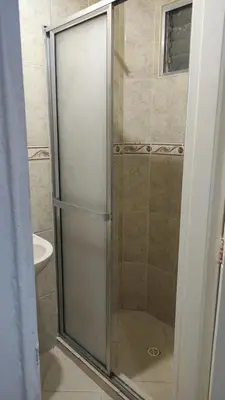a shower with a glass door in a bathroom at Habitación con baño privado#5 in Medellín