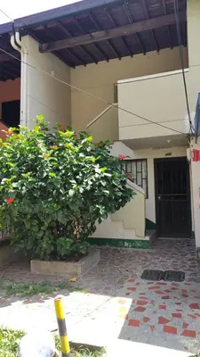 a building with two large bushes in front of it at Habitación con baño privado#5 in Medellín