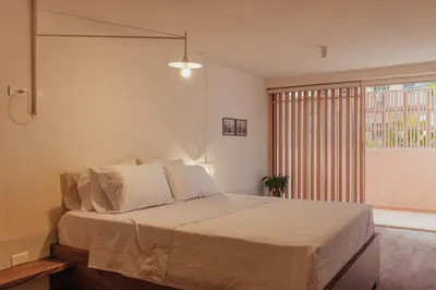 a bedroom with a large bed and a window at NEW Cozy Duplex in Laureles with A/C and WI-FI in Medellín