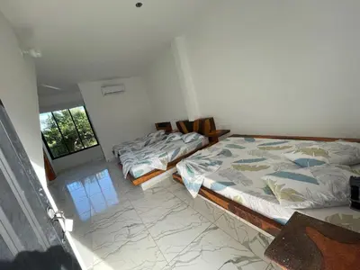 a bedroom with two beds and a window at finca campestre las heliconias in Puerto Triunfo