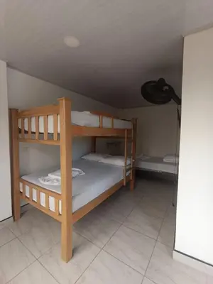 two bunk beds in a room with a ceiling at HOTEL NORCASIA RIOS Y AVENTURAS in Norcasia