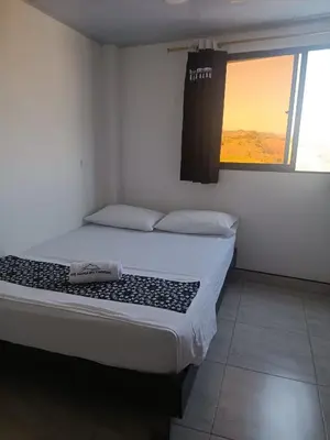 a bedroom with a large bed with a window at HOTEL NORCASIA RIOS Y AVENTURAS in Norcasia
