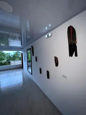 a room with a white wall with art on it at HOTEL NORCASIA RIOS Y AVENTURAS in Norcasia