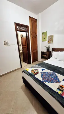 a bedroom with a bed and a door to a room at Volarte Hotel in Jardin