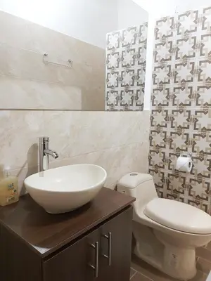 a bathroom with a sink and a toilet at Volarte Hotel in Jardin