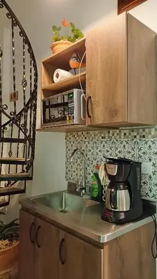 a kitchen counter with a sink and a microwave at Volarte Hotel in Jardin