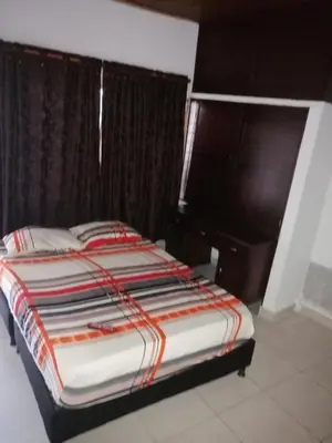 a bedroom with a large bed with a desk at Casa low cost in La Dorada