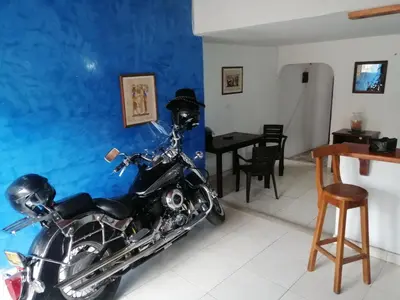 a motorcycle parked in a room with a dining room at Casa low cost in La Dorada