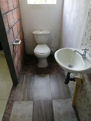 a bathroom with a toilet and a sink at Casa low cost in La Dorada