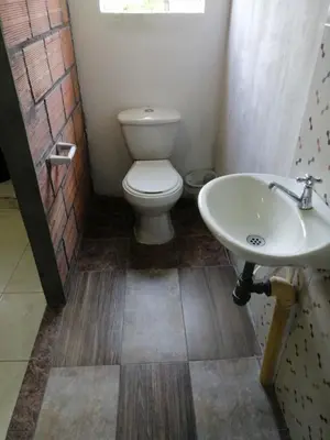 a bathroom with a toilet and a sink at Casa de relajación low cost in La Dorada