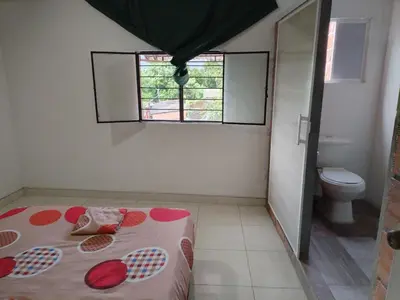 a small bathroom with a bed and a toilet at Casa de relajación low cost in La Dorada