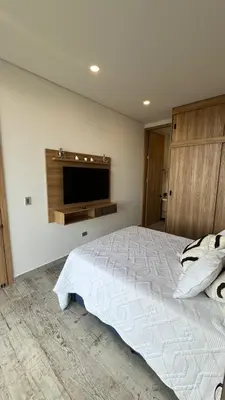 a bedroom with a bed and a flat screen tv at Montecielo Hosting in Guatapé
