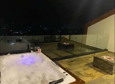 a bath tub in a room with a view at Montecielo Hosting in Guatapé
