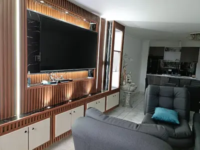 a living room with a large flat screen tv at cool de laureles Medellín in Medellín