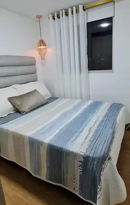a bedroom with a large bed with a window at Casalba in Bello
