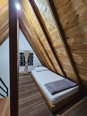 a bed in a room with a wooden ceiling at Chalet Los Sinsontes in San Rafael