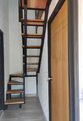 a spiral staircase in a room with a door at Chalet Los Sinsontes in San Rafael