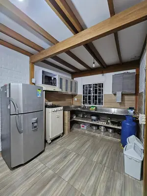 a kitchen with a stainless steel refrigerator in a room at Chalet Los Sinsontes in San Rafael