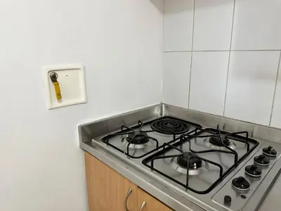 a kitchen with a stove top oven in a kitchen at Amoblados Medellin Poblado Patio Bonito in Medellín