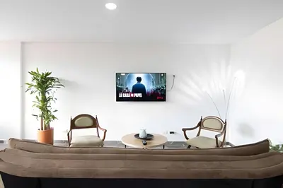 a living room with two chairs and a table at Vistas Top | Parking | Cerca De Estadio y 