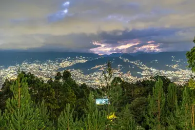 a view of a city from a hill with trees at Poblado Mansion With Hot Tub & A/C Sleeps 9 in Medellín