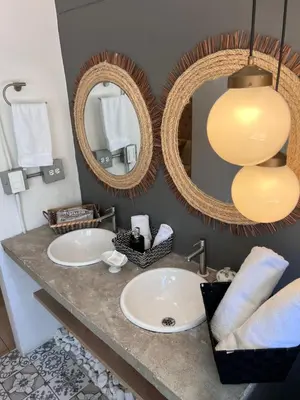 a bathroom with two sinks and two mirrors at PROVENZA LUXURY APARTMENTS TERRAZA in Medellín