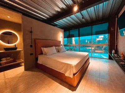 a bedroom with a large bed and a large window at PROVENZA LUXURY APARTMENTS TERRAZA in Medellín