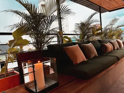 a black couch with pillows and a table on a roof at PROVENZA LUXURY APARTMENTS TERRAZA in Medellín