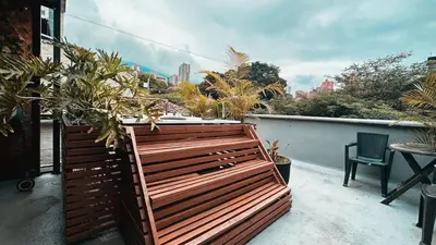 a balcony with a wooden fence and some plants at PROVENZA LUXURY APARTMENTS TERRAZA in Medellín