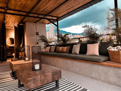 a couch on a patio with a table at PROVENZA LUXURY APARTMENTS TERRAZA in Medellín